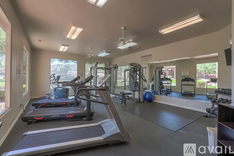 A gym with treadmills, weights, and exercise equipment.