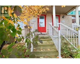 A house with a red door and a white railing.