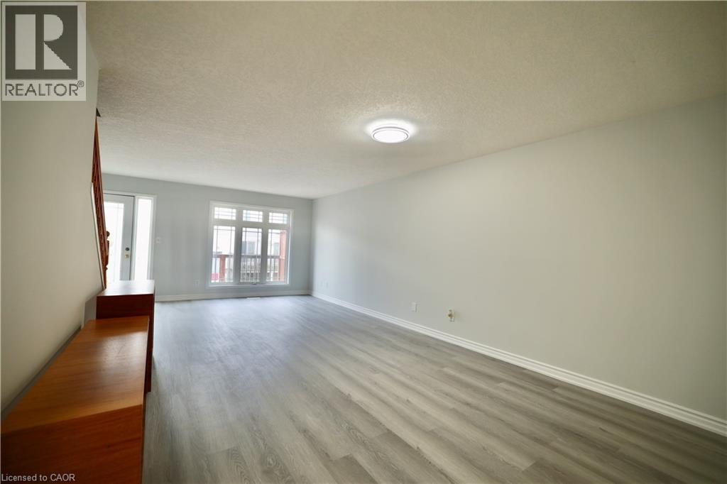 A room with a wooden bench and grey flooring.