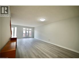A room with a wooden bench and grey flooring.