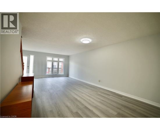 A room with a wooden bench and grey flooring.