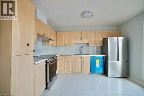 A kitchen with wooden cabinets and a blue fridge.