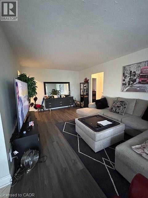 A living room with a grey couch, a coffee table, and a television.