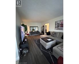 A living room with a grey couch, a coffee table, and a television.