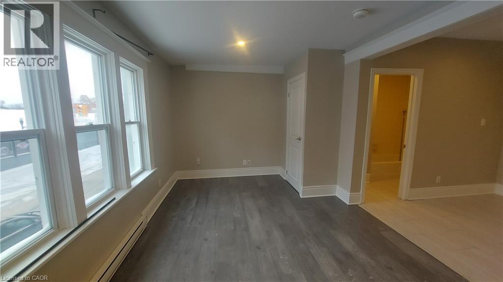 A room with a window and a door is available for rent.