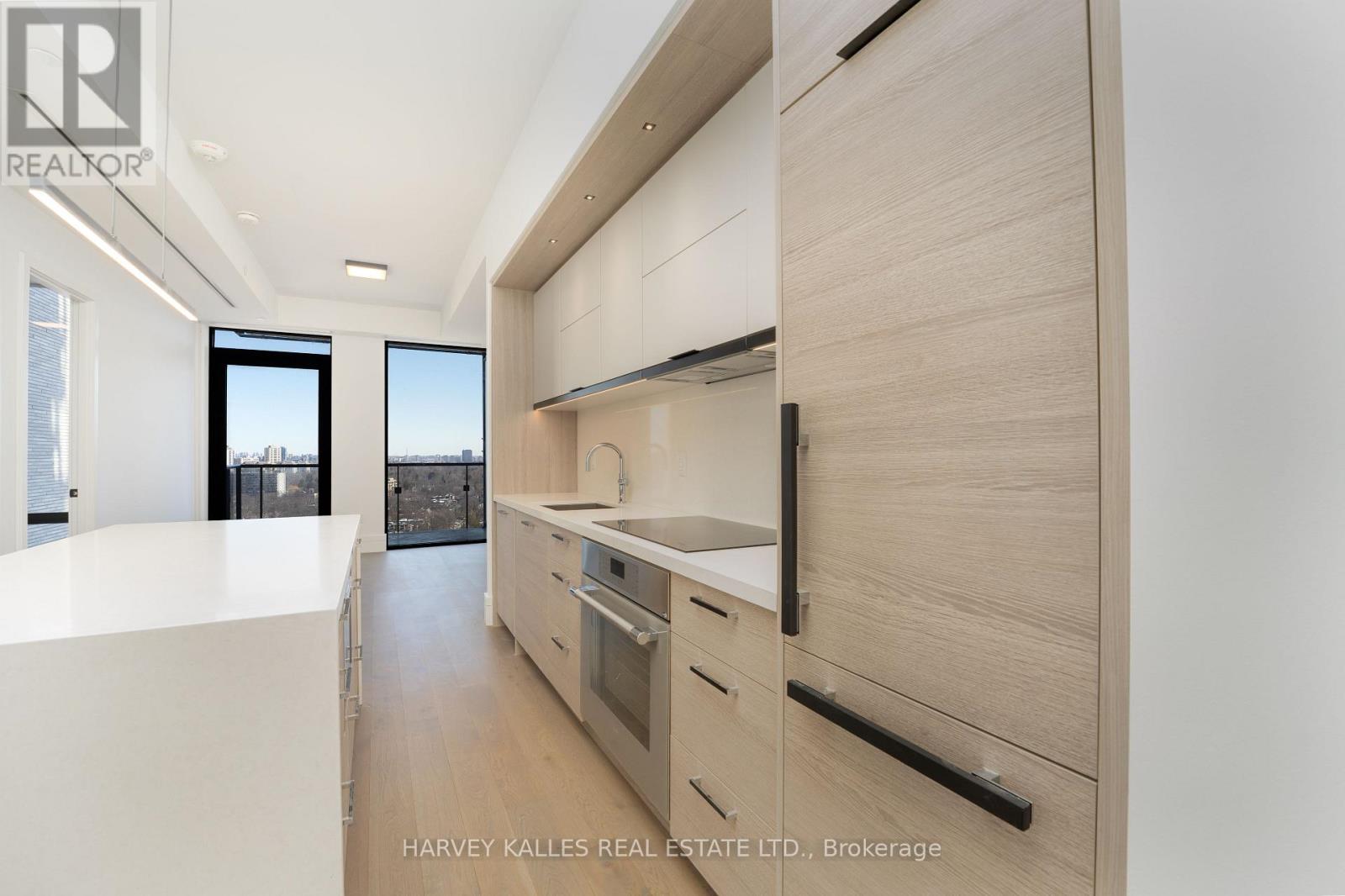 A modern kitchen with wooden cabinets and a white countertop.