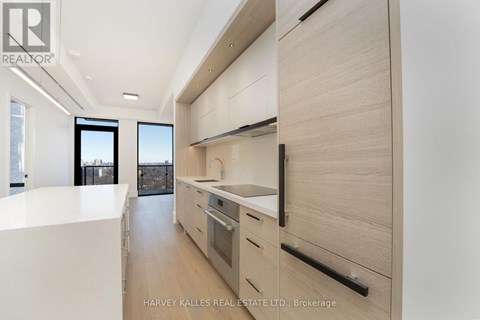 A modern kitchen with wooden cabinets and a white countertop.