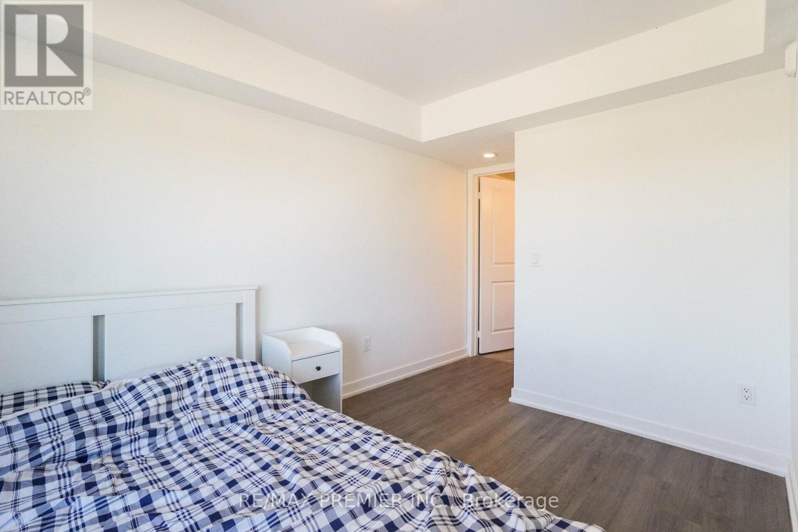 A bedroom with a bed and a nightstand.