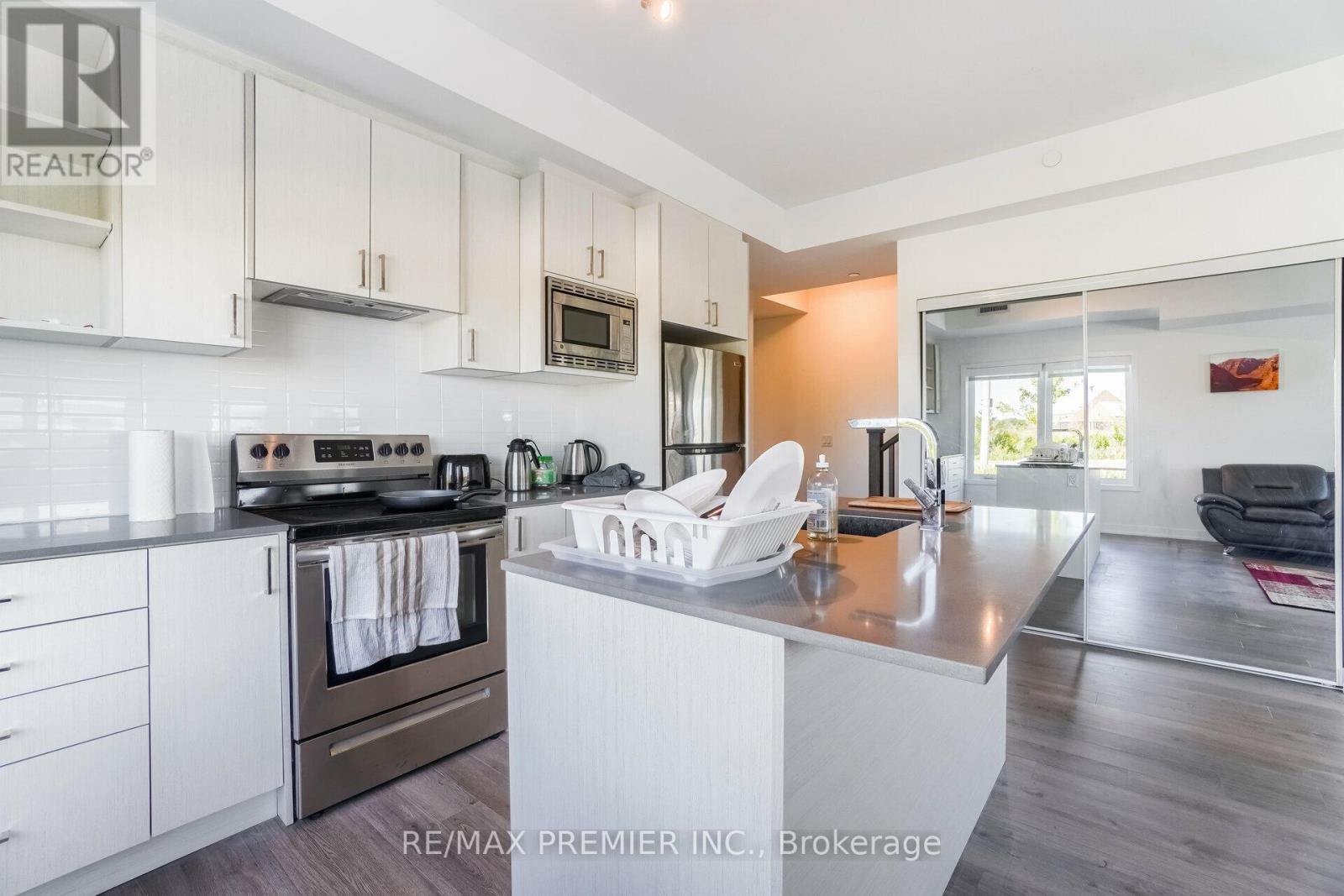 A modern kitchen with white cabinets and a large island.