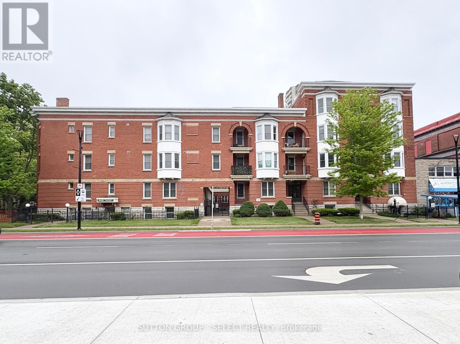 A red brick building with a white door and windows.