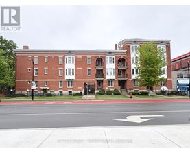 A red brick building with a white door and windows.