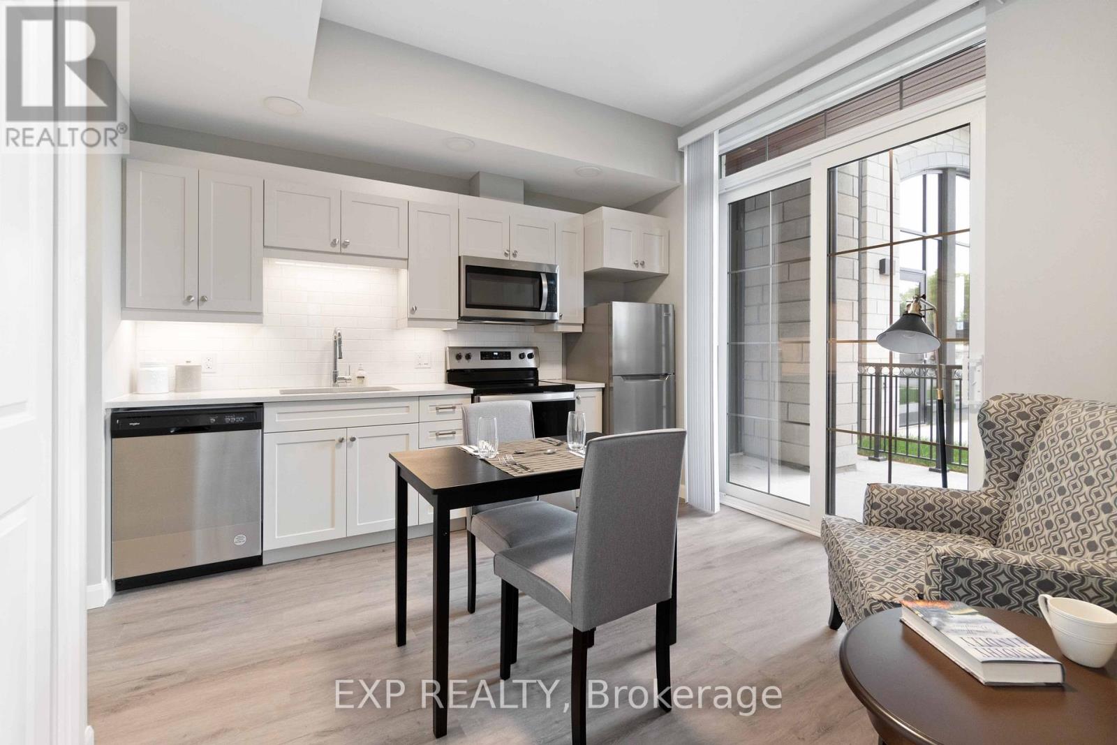 A modern kitchen with a dining table and chairs.