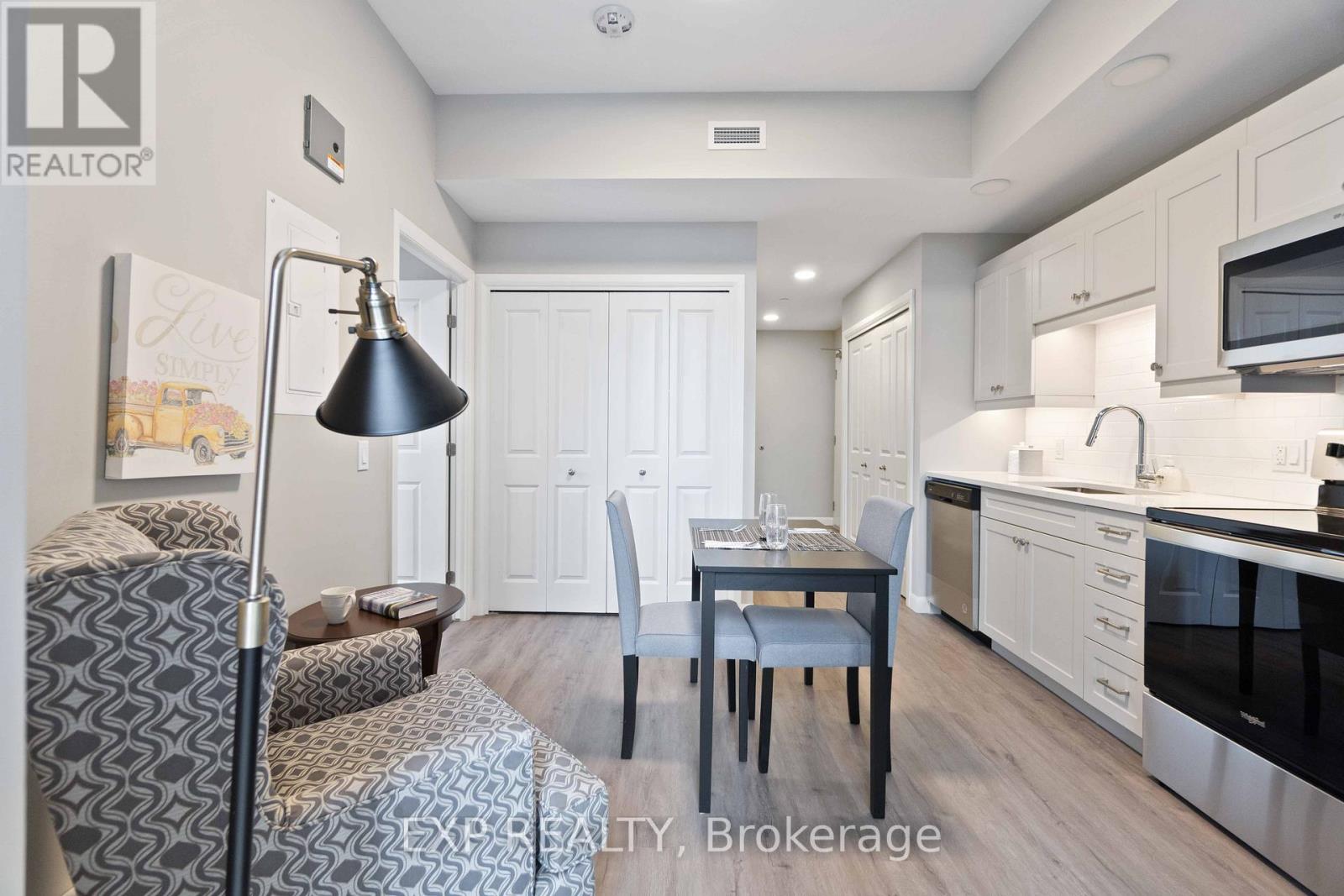 A well-lit kitchen with a dining table and chairs.