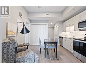 A well-lit kitchen with a dining table and chairs.