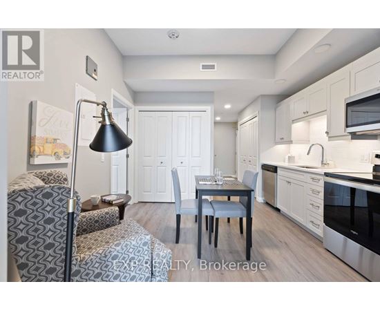 A well-lit kitchen with a dining table and chairs.