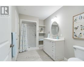 A bathroom with a white vanity and a white toilet.