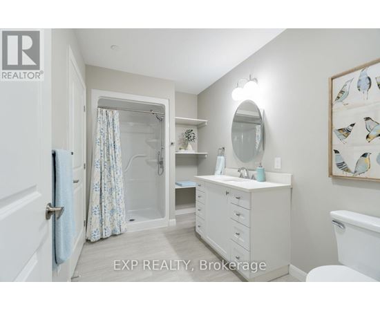 A bathroom with a white vanity and a white toilet.