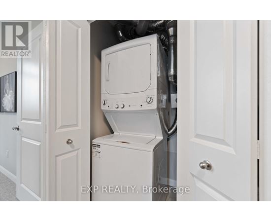 A white washing machine is in a small space between two doors.