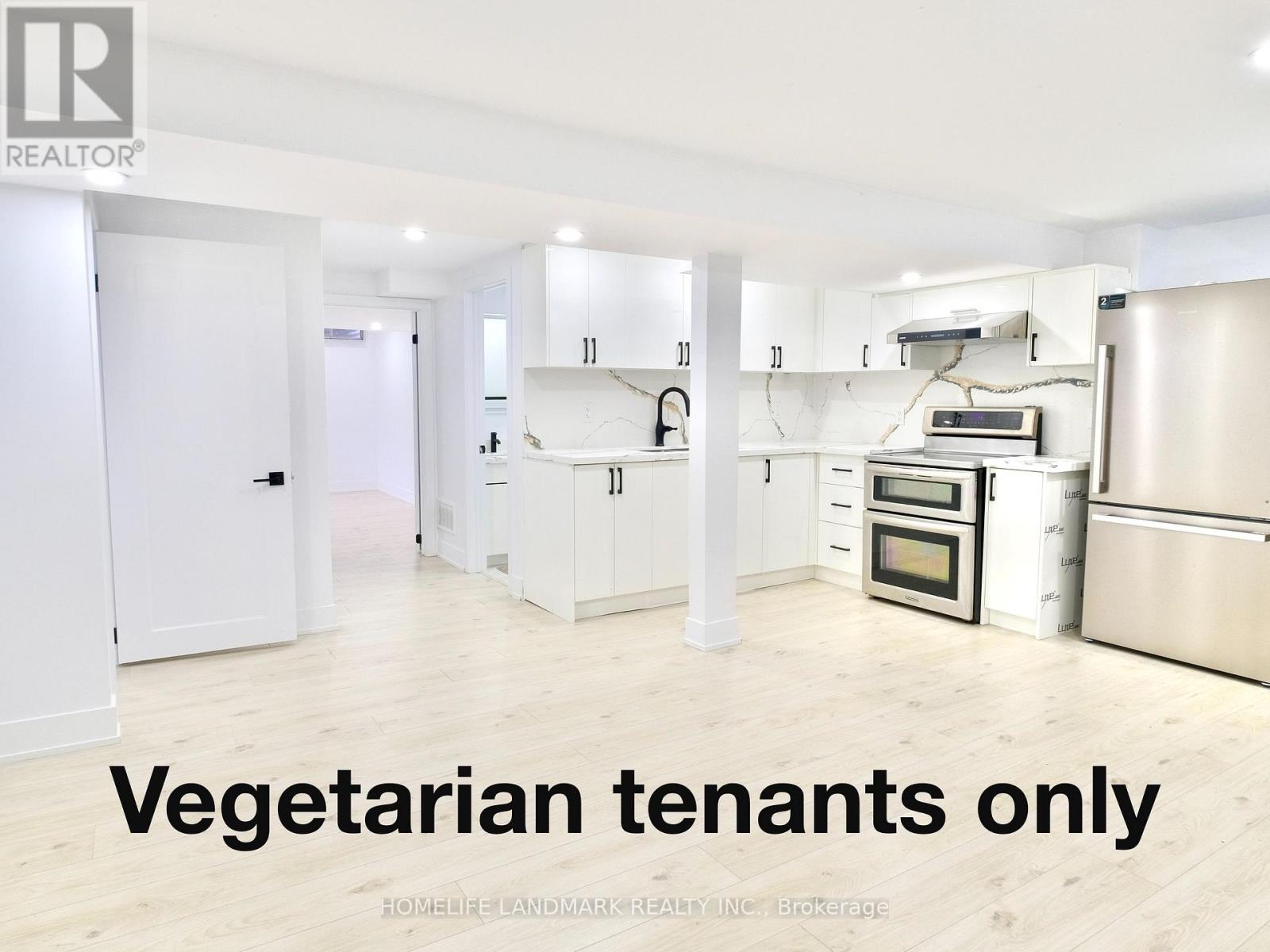 A kitchen with the words vegetarian tenants only written on the floor.