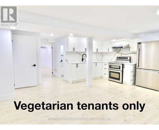 A kitchen with the words vegetarian tenants only written on the floor.