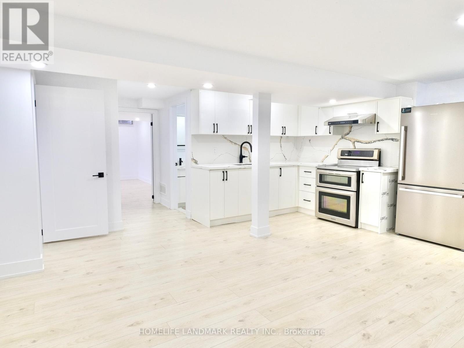 A kitchen with white cabinets and stainless steel appliances.