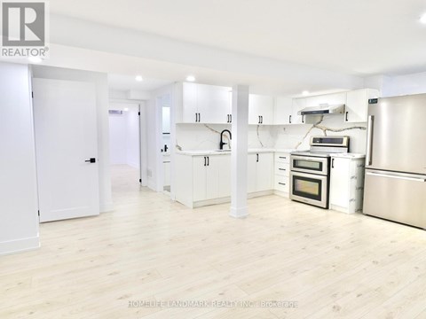A kitchen with white cabinets and stainless steel appliances.