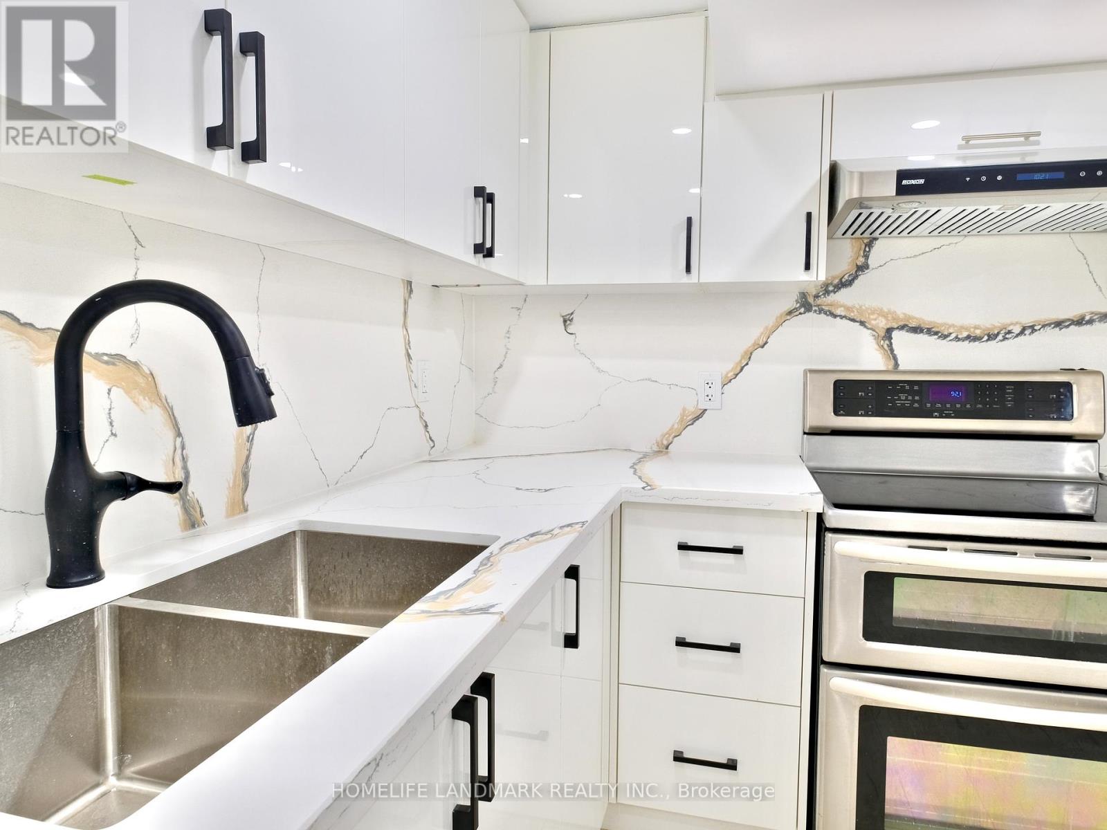 A kitchen with a sink and a counter.
