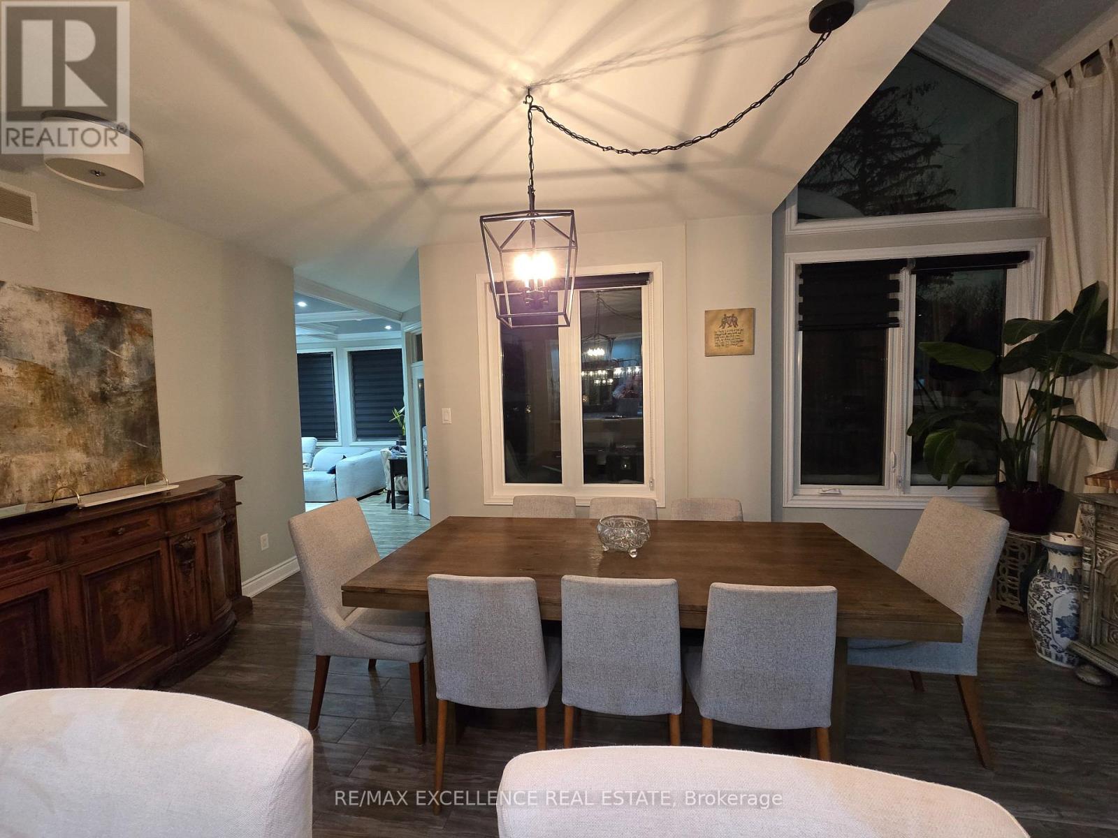A dining room with a wooden table and chairs.
