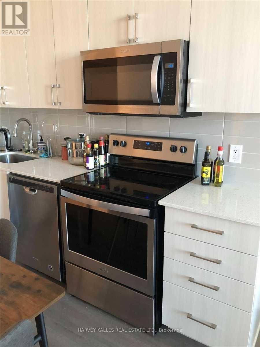 A modern kitchen with a stainless steel oven and microwave.