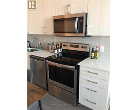 A modern kitchen with a stainless steel oven and microwave.