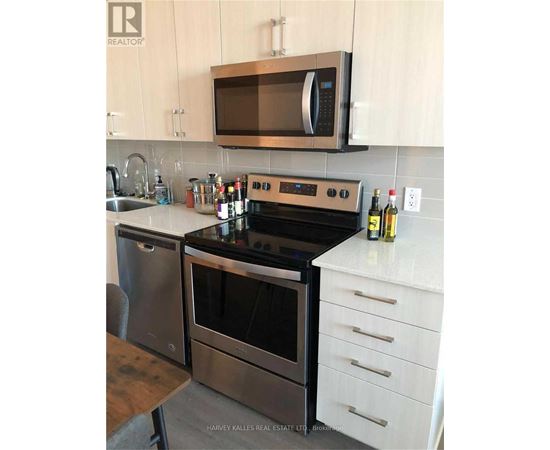 A modern kitchen with a stainless steel oven and microwave.
