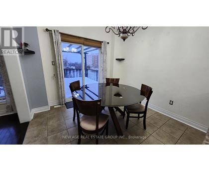 A dining room with a table and chairs and a view of a snowy landscape outside.