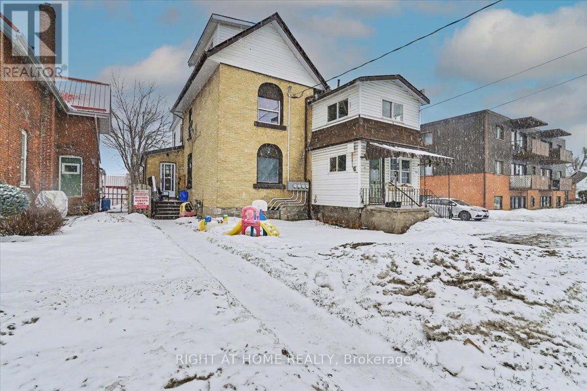 A snowy landscape with a house and a sign that says "REALTOR".