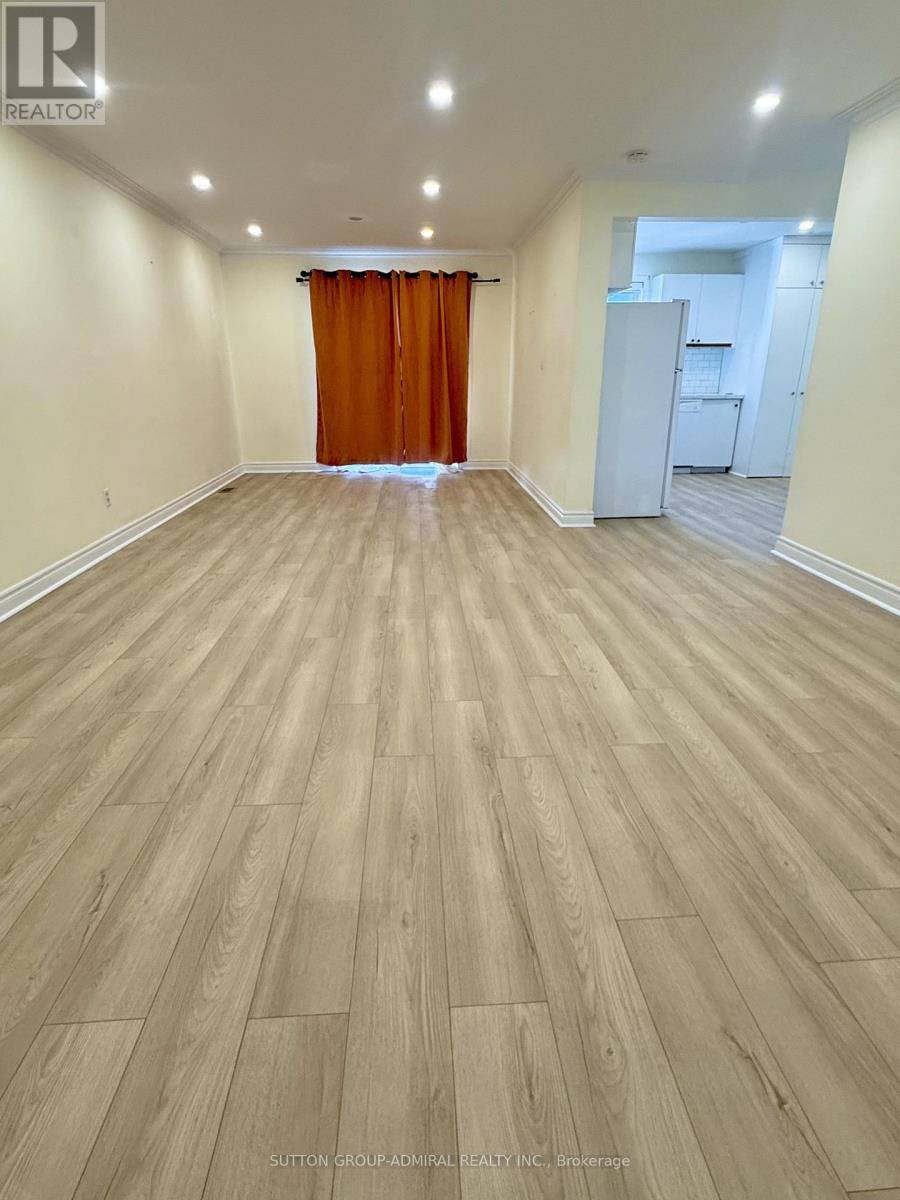 A room with wooden flooring and a curtain in the middle.