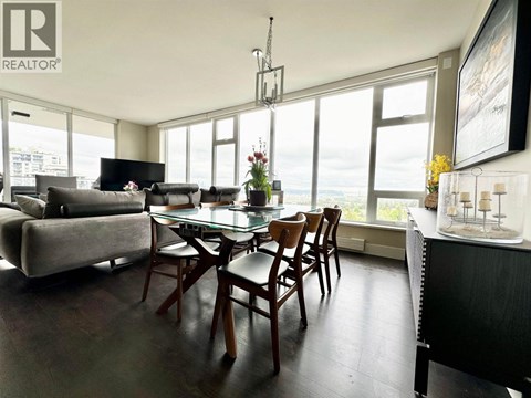 A dining room with a glass table and chairs.