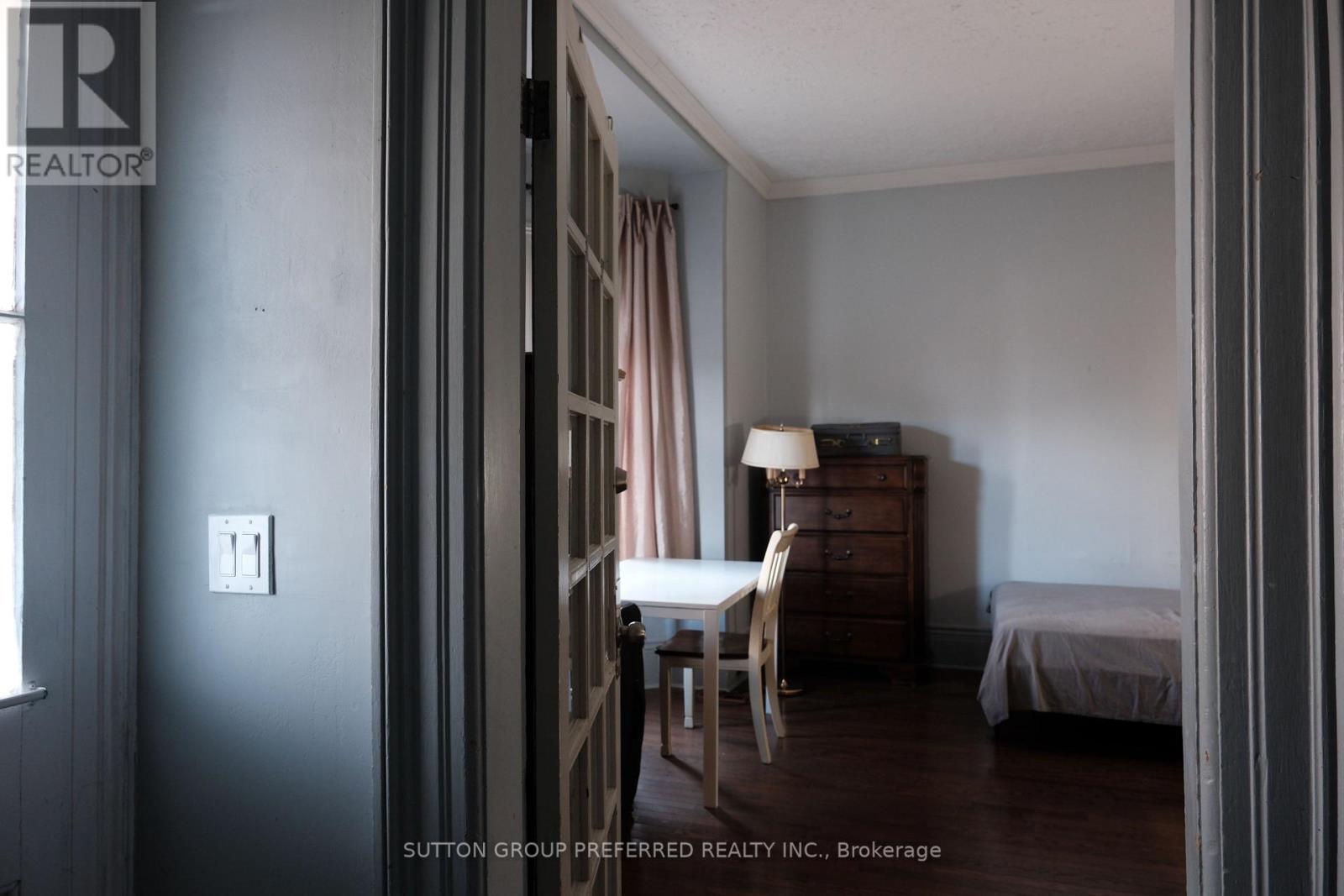 A room with a bed, a chair, and a dresser.