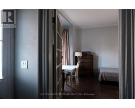 A room with a bed, a chair, and a dresser.