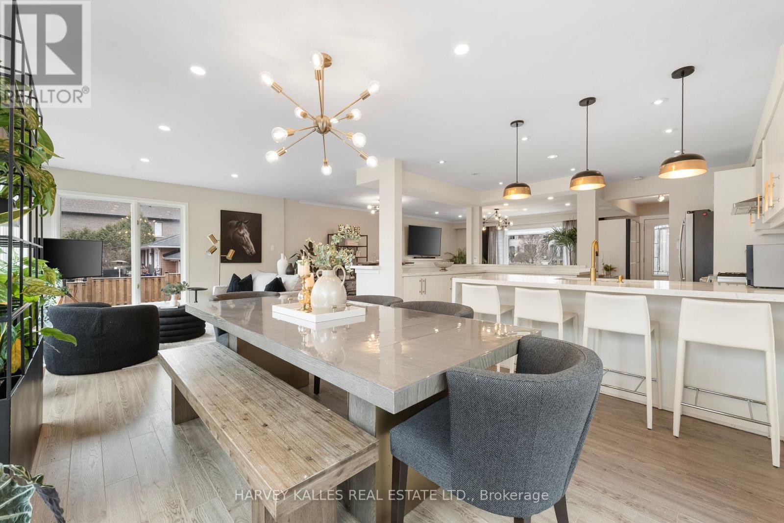 A modern dining room with a large table and chairs.