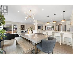 A modern dining room with a large table and chairs.