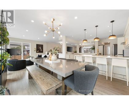 A modern dining room with a large table and chairs.