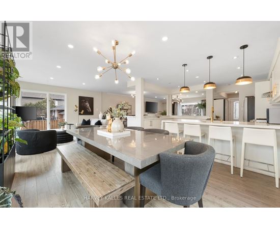 A modern dining room with a large table and chairs.