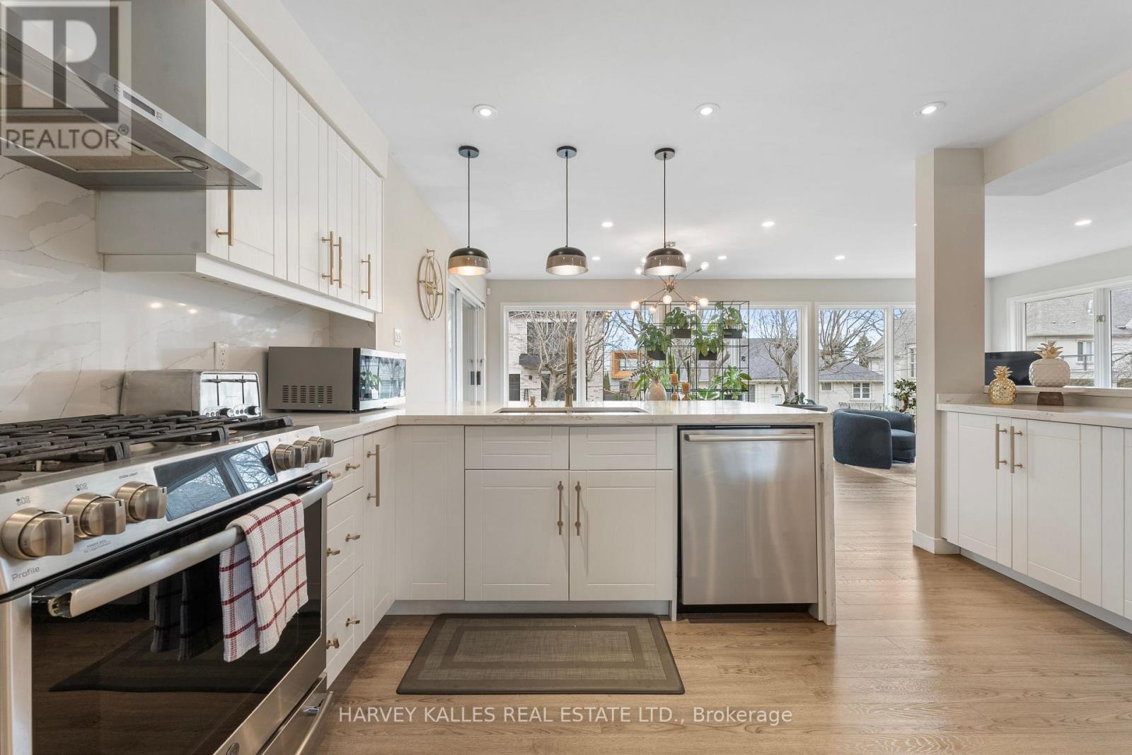 A modern kitchen with a stove top oven and a refrigerator.