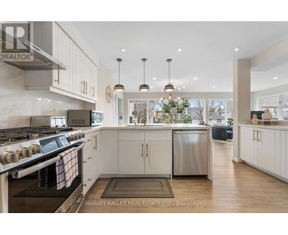 A modern kitchen with a stove top oven and a refrigerator.