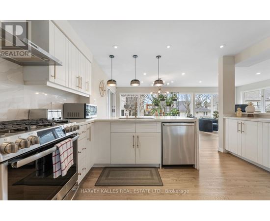 A modern kitchen with a stove top oven and a refrigerator.
