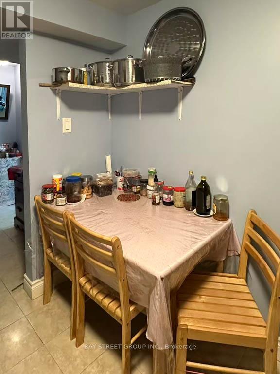 A dining room with a table set for a meal.