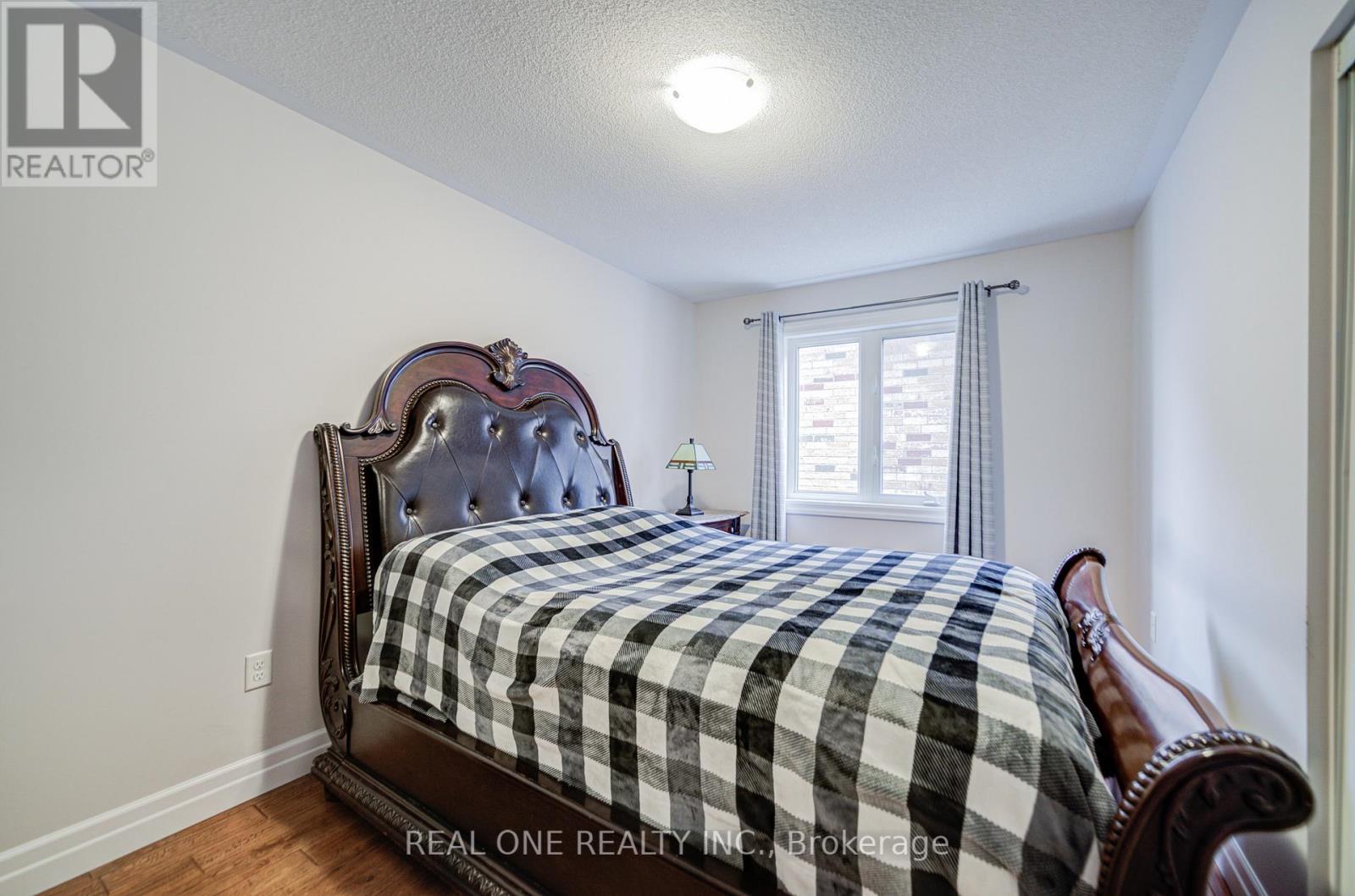 A bedroom with a bed and a window.