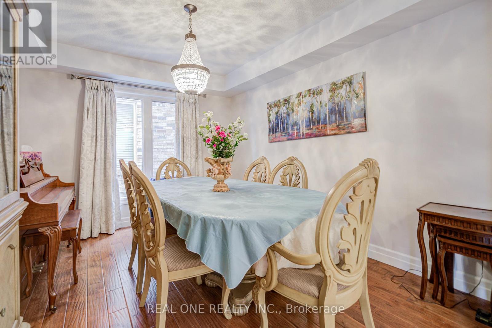 A dining room with a table set for four.
