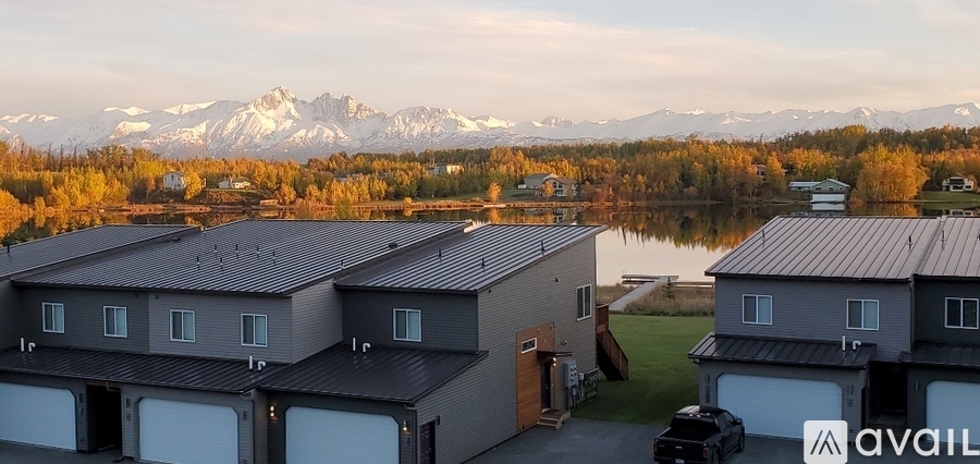 A row of houses with a mountain range in the background.