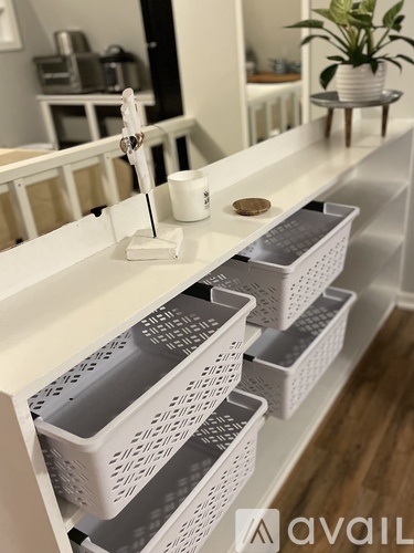 White shelves with baskets and containers on them.