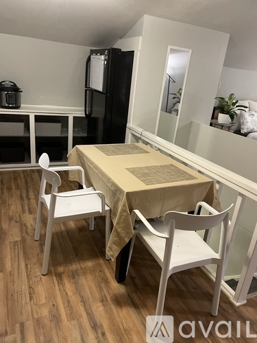 A dining room with a table and chairs.